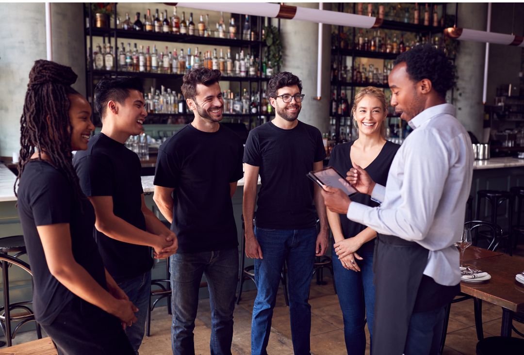 An image of a staff training session—highlighting one of the key tips for successfully using AV installations to transform the restaurant experience. 